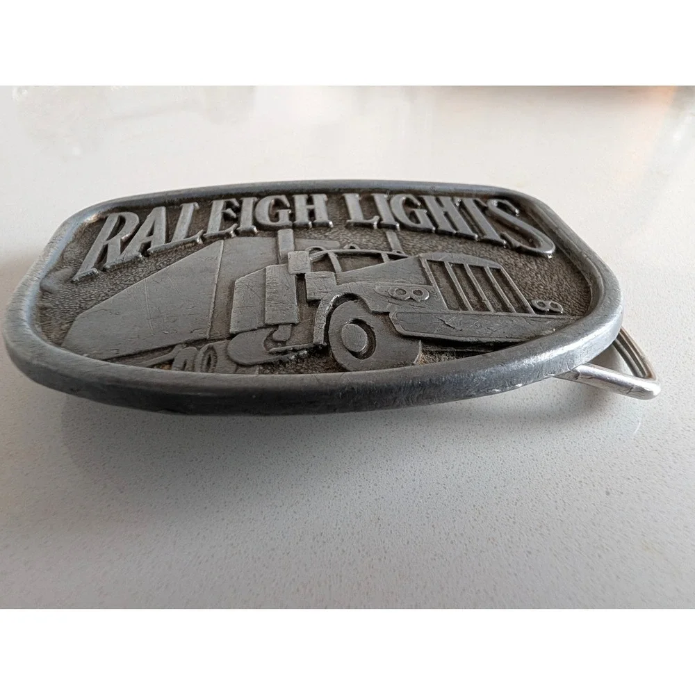 Vintage Raleigh Lights Semi Truck Belt Buckle Pewter Tone Tobacco Promo Big Rig